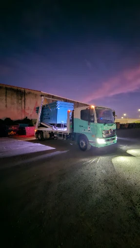 Jesse's Get It Done Skips truck loaded with a skip bin at dusk in Brisbane